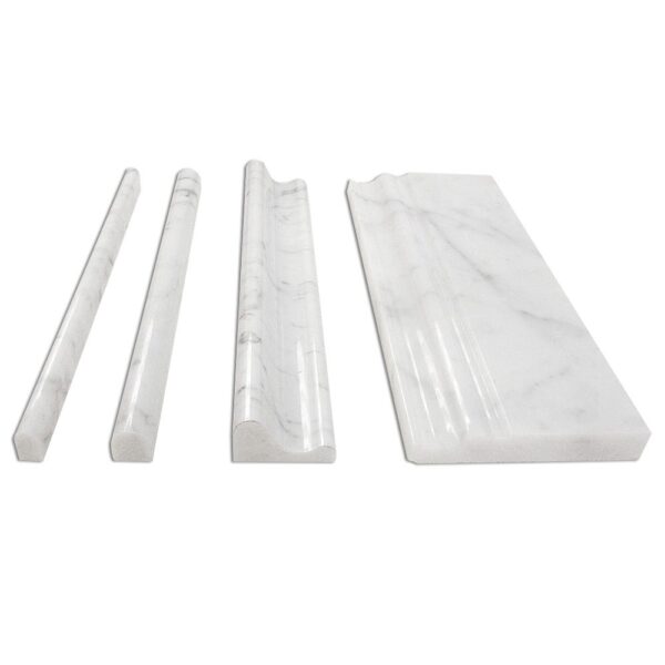 Four pieces of Bianco Carrara Mouldings on a white surface.