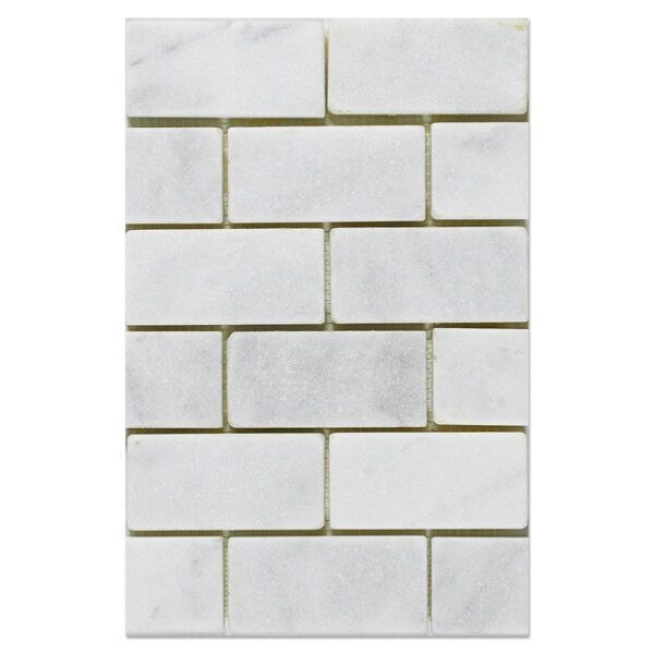A Milano White tumbled mosaic 2x4 tile with a white background.