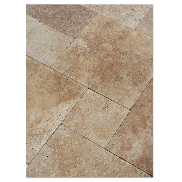 A close up of a noce travertine tumbled paver pattern set floor with brown and tan tiles.