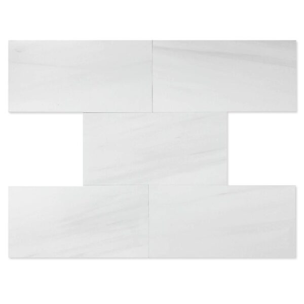 A white tile wall with two pieces of it