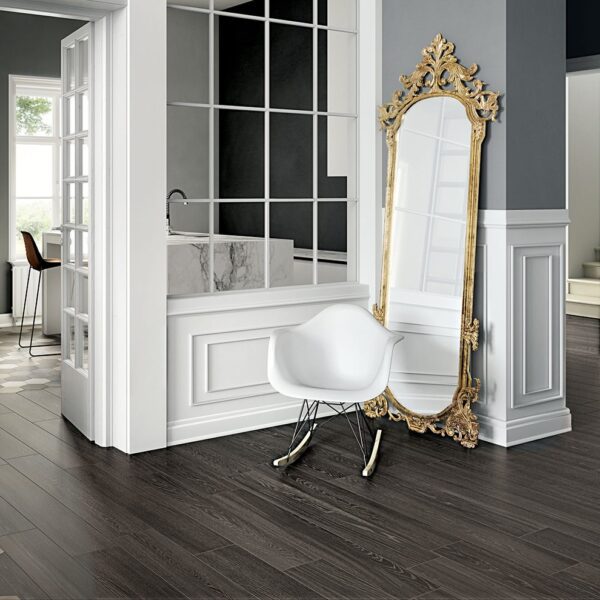 A white chair and mirror in a room.