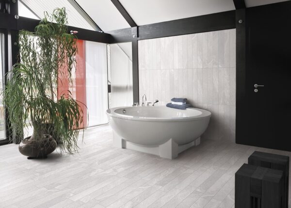A bathroom with a tub and plants in it