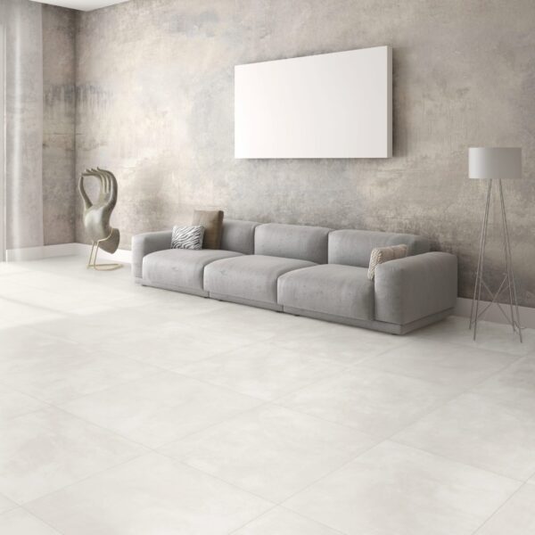 A white tiled living room with a grey couch.