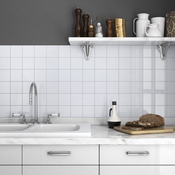 A white kitchen with a sink and counter