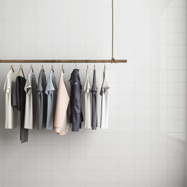 A row of shirts hanging on a rack.