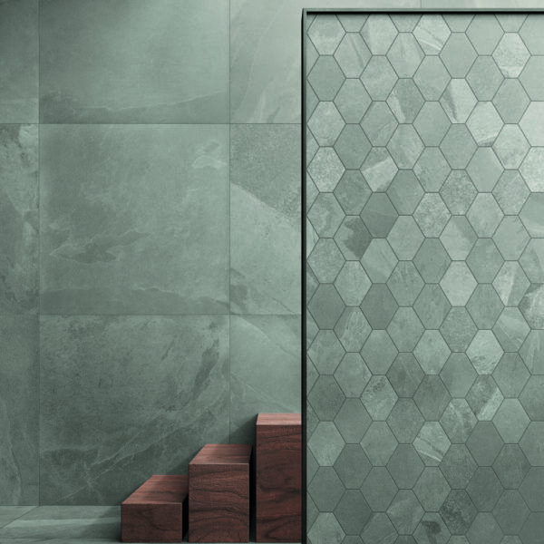 A green tiled wall with wooden steps in front of it, featuring 24x24 Silk Gray tile.