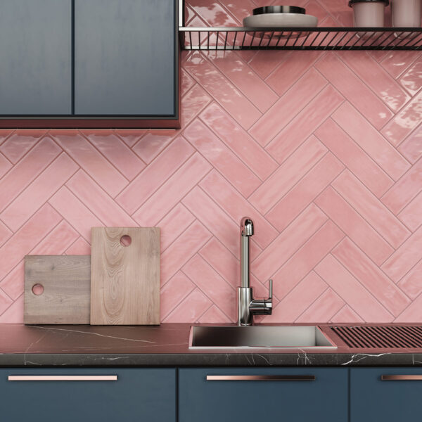 A kitchen with pink tile and blue cabinets